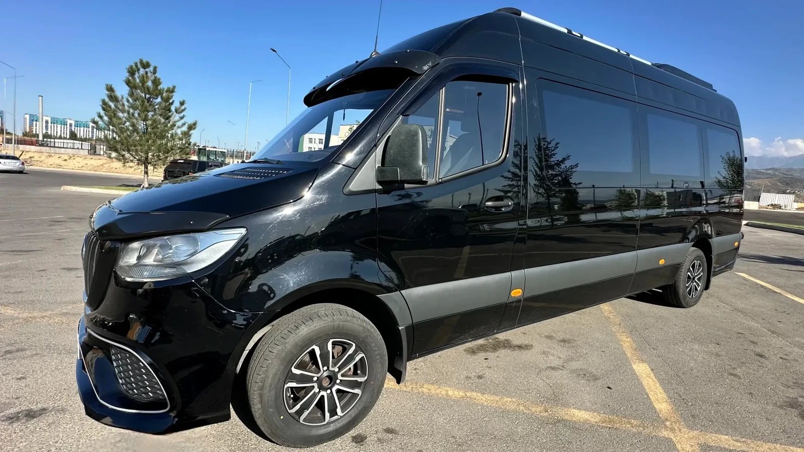 Чёрный Mercedes-Benz Sprinter на 16 мест в дневном уличном ракурсе